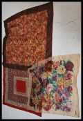 A group of three vintage early 20th Century designer silk scarves to include two by Liberty and Co
