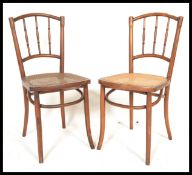 A pair of early 20th Century bentwood bedroom chairs in the manner of Thonet having bergere seats.