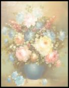 A 20th Century oil on canvas still life painting depicting a vase of peony flowers softly painted on