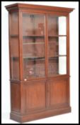 A large 19th Century Victorian mahogany glazed bookcase, two glazed doors with adjustable shelves to