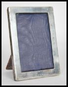 An early 20th Century hallmarked silver easel back photograph frame of rectangular form bearing
