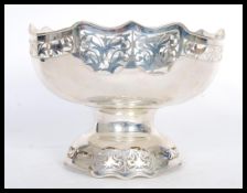 A large and impressive silver white metal table centerpiece bowl raised on pedestal base with fret