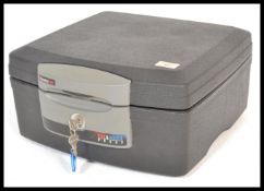 A Fire and Waterproof Sentry Safe having a lock and key to the front with hinged lid opening, having