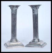 A pair of early 20th Century William Devenport hallmarked silver candlesticks in the form of