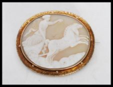 A 19th Century Victorian cameo brooch having a carved conch shell panel depicting the Goddess set
