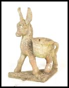 A vintage 20th Century well weathered reconstituted stone garden sculpture modelled as a donkey, the