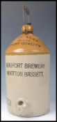 A large early 20th Century salt glazed stoneware cider bottle for Beaufort Brewery Wootton Bassett