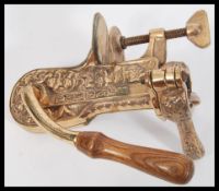 An antique style table mounted bronze effect wine bottle opener corkscrew having relief gilt