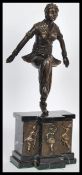 An early 20th Century Art Deco bronze figurine of a flapper girl raised on shaped marble base with