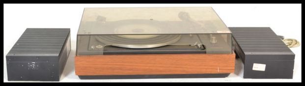 A vintage B&O Bang And Olufsen record deck with acrylic hood and teak wood case dating to the 1970'