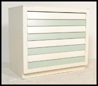 A retro 20th Century two tone painted beehive chest of drawers, the four drawer chest of drawers