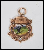 An early 20th Century Edwardian hallmarked 9ct gold fob medal of armorial form. Enamel cartouche