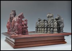 A vintage 20th Century large resin chess set having an Animal Kingdom theme complete with associated