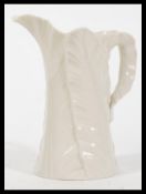 An early 20th Century Royal Worcester ceramic leaf jug or larger form having date cypher to base for