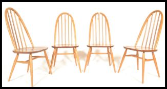 A set of four mid 20th century Ercol Windsor Quaker hoop-back dining chairs in light elm and