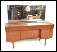 A retro 20th Century teak wood dressing table by Nathan, having a configuration of drawers and
