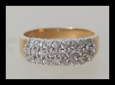 A hallmarked 9ct gold ring having three rows of white stones in white gold setting. Weighs 3.4