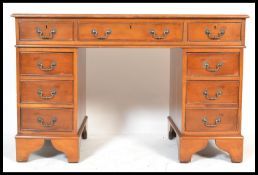 A 20th Century antique style yew wood twin pedestal office writing desk having two banks of