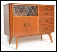 A vintage retro 20th Century Art Deco walnut veneered sideboard cabinet raised on splayed legs