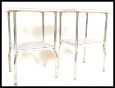 A pair of 20th Century retro industrial bedside tables having two graduating metal shelves raised on