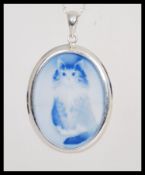 A stamped 925 silver necklace having a large blue cameo pendant having an engraved cat. Weight 12.