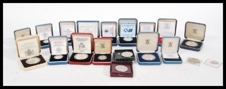 A selection of boxed proof coins to include eight boxed silver pound coins dating from the 1980's,
