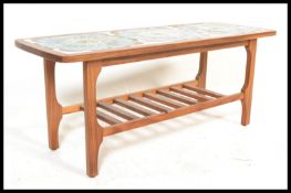 A vintage retro 20th Century teak wood tile top coffee table having a sectional vibrant blue retro