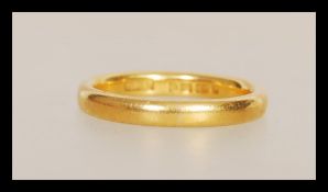 A 22ct gold wedding band ring having hallmarks for London dating 1939 and stamped W.W.Ld. Weight 3.