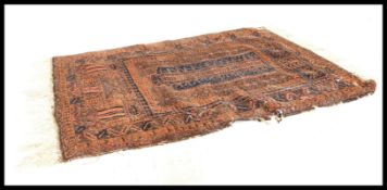 A 19th Century Persian ISlamic floor carpet rug having a deep pile wool red ground with hand woven