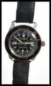 A vintage Adrem water protected antimagnetic divers watch having a round black face with luminous