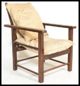 A 1920's Art Deco Morris fire side children's chair, having adjustable ladder backrest,