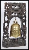 A vintage 20th Century hand carved Chinese ebonised prayer altar gong bell having dragon