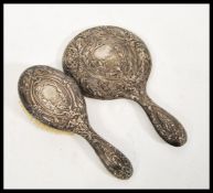 An early 20th Century hallmarked silver brush and mirror vanity set consisting of large mirror