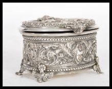 An early 20th Century jewellery casket / box in the Rococo taste, the hinged lid depicting cupid