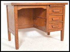 A small early 20th century oak single pedestal desk, having single pedestal with three drawers and