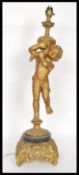 A 20th Century cast metal table lamp in the form of a cherub, raised on a scrolled acanthus leaf