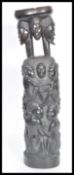 A 20th Century carved hardwood African tribal totem with bowl to the top, having carved figures to