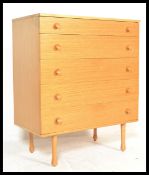 A vintage / retro 20th Century teak wood chest of five graduating drawers raised on tapering