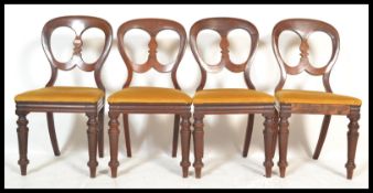 A set of four matching 19th Century mahogany balloon back dining chairs having central rail with
