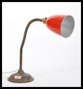 A vintage retro 20th Century industrial gooseneck table desk lamp raised on stepped circular base