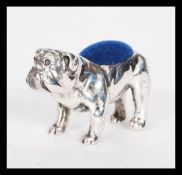 A stamped 925 silver pin cushion in the form of a bulldog having a blue pincushion to the back.