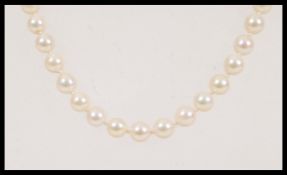 A 20th Century vintage string of cultured pearls approx 60 pearls on a knotted string, having a