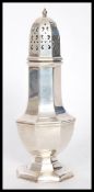 A 20th century silver plated sugar shaker of octagonal form having a pierced dome to the top.