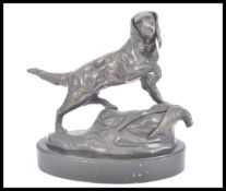 A 20th Century bronze / bronzed figurine of a hunting dog red setter raised on naturalistic base.
