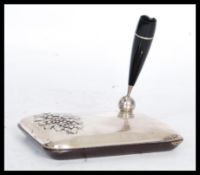 An unusual Italian silver 925 on wood pen stand having embossed floral spray with bakelite pen