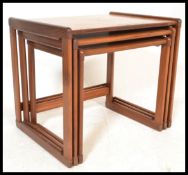 A 1970's G-Plan teak wood nest of tables having shaped legs united by stretchers with graduating