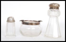 A 20th Century cut glass cruet in the form of a thistle having a silver hallmarked top (hallmarked