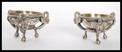 A pair of early 20th Century silver plated open table salt cellar condiments raised on tripod