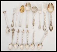 A selection of mixed silver cutlery items to include spoons and knives dating from the 19th