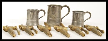 A collection of 20th century breweriana brass beer taps having lever handle action together with two